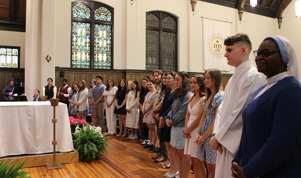 Ten students in the Rite of Christian Initiation of Adults, or RCIA, process completed their Initiation into the Sacramental Life of the Catholic Church. They are shown with their sponsors at Madonna della Strada Chapel after receiving Confirmation.