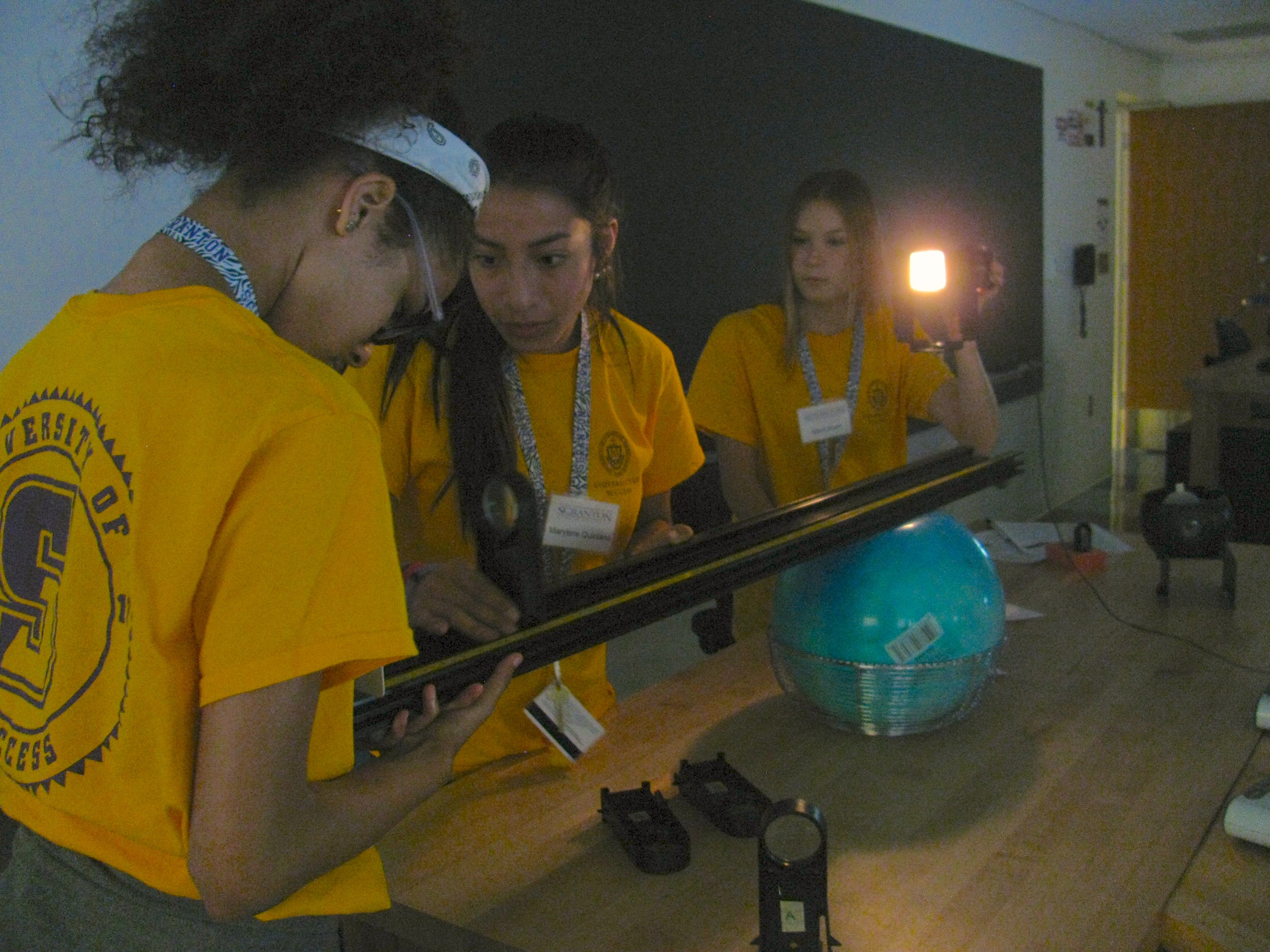 From left: University of Success students Maria Eduarda Do Vale, Marytere Quintana and Mauri Kurin participate in a hands-on project for a physics class taught by University professors as part of the Summer Institute.