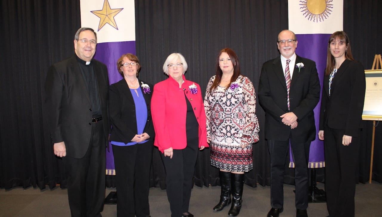 The University of Scranton presented Sursum Corda (Lift Up Your Hearts) Awards to four staff members at a convocation held on campus this month. The award recognizes members of the University’s professional/paraprofessional staff, clerical/technical staff and maintenance/public safety staff who have made outstanding contributions to the life and mission of the University. Pictured, from left, are Rev. Herbert B. Keller, S.J., interim president at the University; Sursum Corda Award recipients: Margaret Hynosky, Catherine Mascelli, Jennifer Pennington and Tim Barrett; and Patricia Tetreault, associate vice president for human resources.