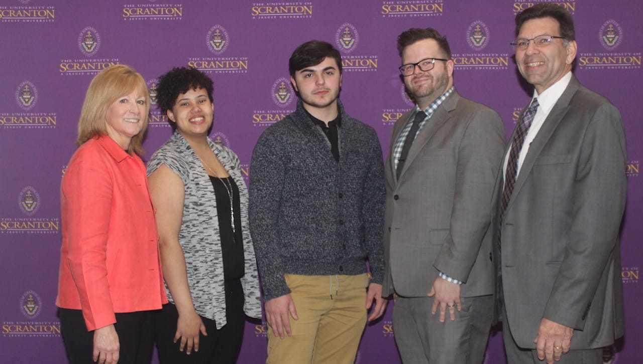 Representatives from Wells Fargo spoke about saving for college to high school students participating in The University of Scranton’s University of Success. From left: Margaret Loughney, University of Success program director; University of Success students Izabell Hearst of Wilkes-Barre (Meyers Junior Senior High School) and Navruz Kadyrov of Scranton (Scranton High School); William Latshaw, personal banker, Wells Fargo, and Michael Pany, community relations senior consultant, Wells Fargo.