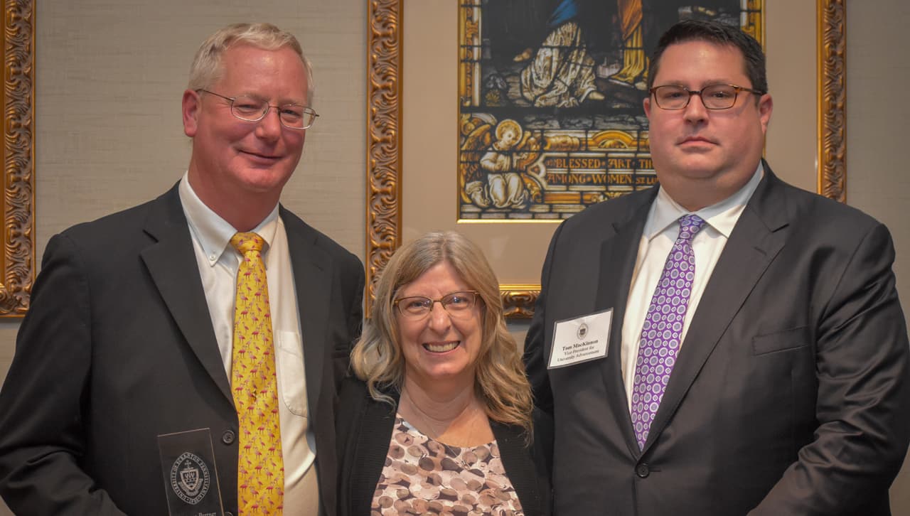 From left, John Heim, president of A.J. Guzzi General Contractors, Inc., enjoys a moment with his wife, Carol Heim, and Vice President for University Advancement Tom MacKinnon at the Business Partner Appreciation Dinner. 
