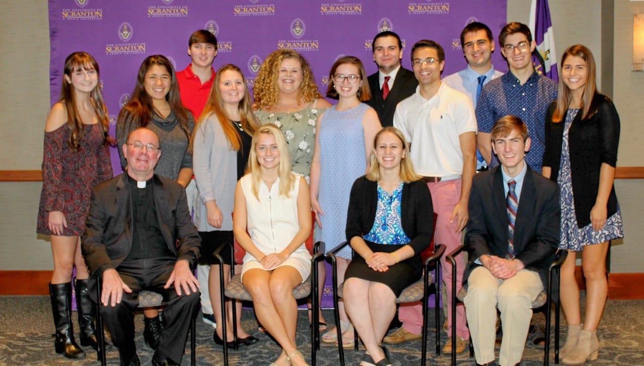 Fourteen students from the University of Scranton class of 2022 have been awarded four-year, full-tuition Presidential Scholarships. Seated, from left, are Rev. Scott R. Pilarz, S.J., president of The University of Scranton; and Presidential Scholars Meghan Rohr, Jessica Goldschlager and Charles Kulick. Standing, from left, are Presidential Scholars Erin Horan, Colleen Chan, Robert Maloney, Ashley Mullan, Anna Wengyn, Sarah White, Eric Dittmar, Sean Connolly, Jacob Shomali, Patrick Dawid and Shannon Brokerick. 