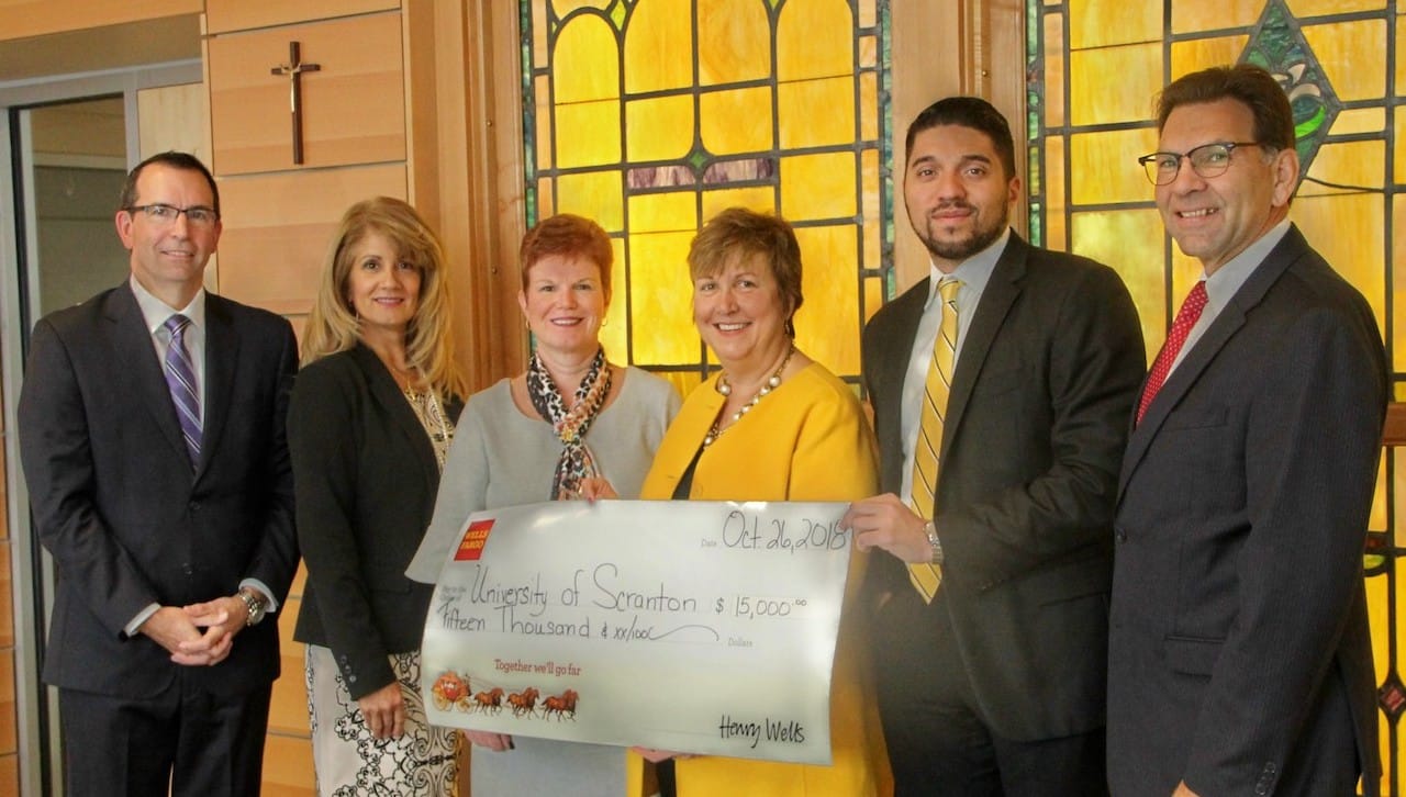 Wells Fargo contributed $15,000 to The University of Scranton’s University of Success, a multi-year, pre-college program for high school students. From left are: Frank Subasic, regional brokerage manager, Wells Fargo Advisors; Jannette Moran, program manager, Wells Fargo; Meg Hambrose, director of corporate and foundation relations at the University; Debra Pellegino, Ed.D., dean of the University’s Panuska College of Professional Studies; Oiram Santos, district manager, Wells Fargo; and Michael Pany, community relations, Wells Fargo.
