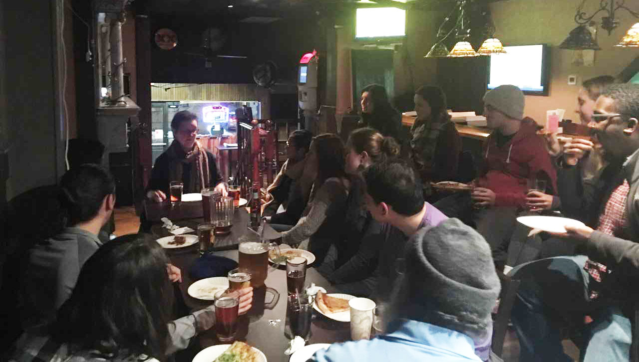 Dr. Maria Poggi Johnson engages in dialogue with students at the Wine Cellar during the November Theology on Tap.