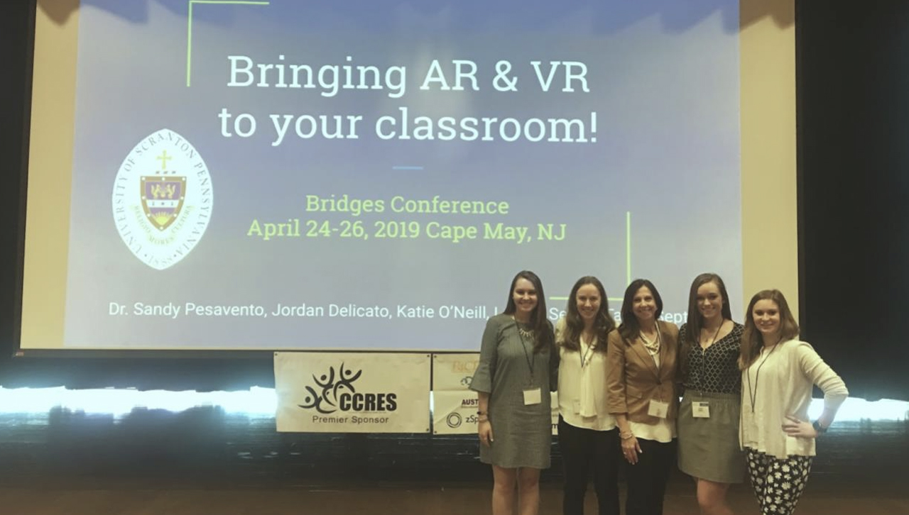 The work of four University of Scranton students, along with their professor, was presented at the P4CE Bridges Conference in Cape May, New Jersey, in April. Standing from left, are University students Lauren Seitz and Katie O’Neil, Dr. Sandra Pesavento a faculty specialist in educational technology and moderator of SECUS, and University students Taylor Septer, and Jordan Delicato.