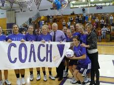 Coach Mike Strong is joined by members of the Lady Royals Basketball Team after Strong recorded the 700th victory of his career.