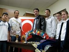 International students from Turkey used artifacts, amulets, images, flags and food to inform students from St. Stanislaus Elementary School and Fell Charter about their homeland at The University of Scranton's celebration of International Education Week. Standing are, from left, Fell Charter students Luis Melgar of Simpson and Isaiah McCord of Carbondale; international students from Turkey Harun Gultekin and Erkan Acar; and St. Stanislaus Elementary School students Joshua Bozym and Hannah Makowski, both of Scranton.