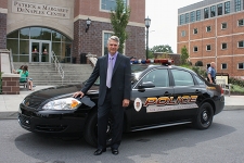 Donald Bergmann, director of public safety and chief of police, stands next to a University Police vehicle. Through the summer months, University Police Officers engaged in extensive training that exceeded requirements of municipal police departments in order to complete the transition into a full service, professional police force. 