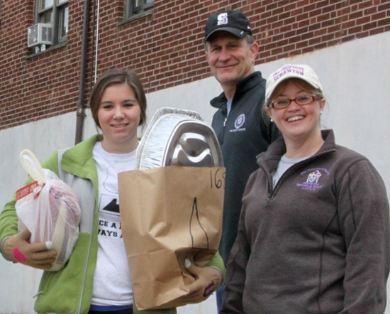 The University of Scranton was named to 2014 President’s Higher Education Community Service Honor Roll. Each year, more than 2,800 University students perform well over 170,000 service hours. Annual service events include a Thanksgiving Food drive. Among the volunteers delivering the 200 Thanksgiving food baskets are, from left, University student Kaitlyn Davis of South Abington Township, Criminal Justice Professor Harry Dammer, Ph.D., and Ellen Judge, from the University’s Center for Service and Social Justice.