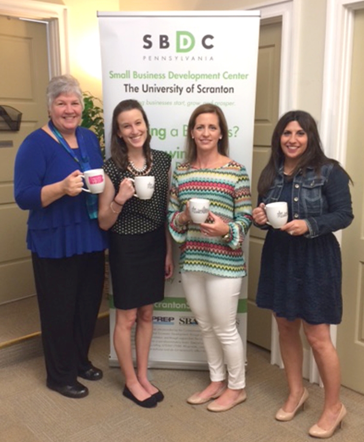 Representatives from The University of Scranton’s Women’s Entrepreneurship Center and the SBDC meet with entrepreneur Alison Skoff, a personal development coach, to plan for the upcoming “Coffee and Confidence,” a free information session on May 13 for women with lower incomes interested in learning about self-employment. From left are: Donna Simpson of Olyphant, consultant manager at the University’s SBDC; University’s Women’s Entrepreneurship Center student intern Larissa Hoffmann ’ 15 of Sussex, New Jersey; Skoff; and Francene Pisano Dudziec of Moosic, special projects coordinator at the University’s SBDC.