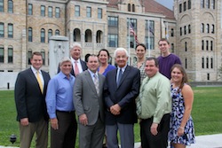Representatives from The University of Scranton met with community partners to plan its “Back to School Bonanza,” a free fair for area children and their families set for Sunday, Aug. 23, from 2 to 4 p.m. at Lackawanna County Courthouse Square. Front row, from left: Justin MacGregor, community relations, Scranton School District; Dave Valvano, chief of staff, State Representative Frank Farina; State Representative Marty Flynn; Lackawanna County Commissioner Edward Staback; Lackawanna County Commissioner Patrick O’Malley; and Keri Thorpe, orientation team leader, The University of Scranton. Second row: Christopher DiMattio, La Festa Italiana president; Patricia O’Rourke Cummings; coordinator of clubs, organizations and student government, The University of Scranton; Julie Schumacher Cohen, director of community and government relations, The University of Scranton; and Ryan Burdick; community relations intern, The University of Scranton.