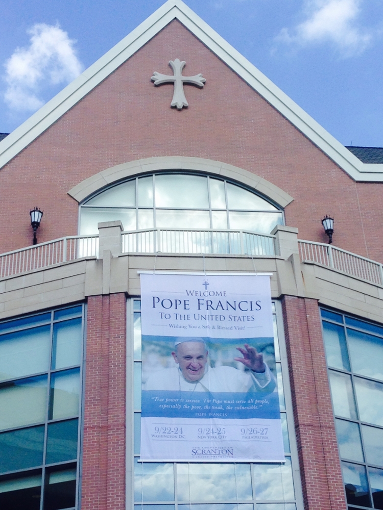 The University of Scranton displays a welcome banner for Pope Francis on the DeNaples Center.