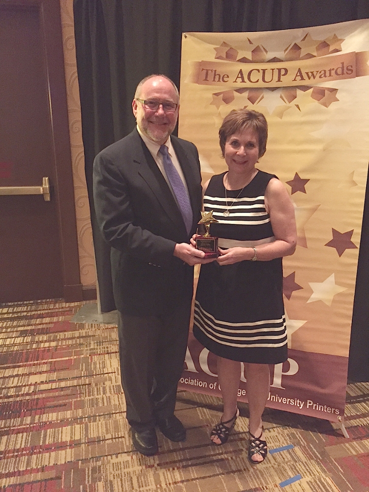 Richard Tussy, president of the Association of College and University Printers (ACUP), presents ACUP’s Distinctive Service Award to Valarie Clark, director of Printing and Mailing Services, on behalf of The University of Scranton.