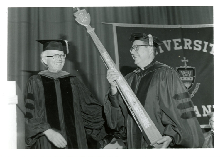 Rev. William J. Byron, S.J. hands the University’s mace to his successor, The University of Scranton’s 22nd President Rev. Joseph Allan Panuska, S.J., at his inauguration in 1982.