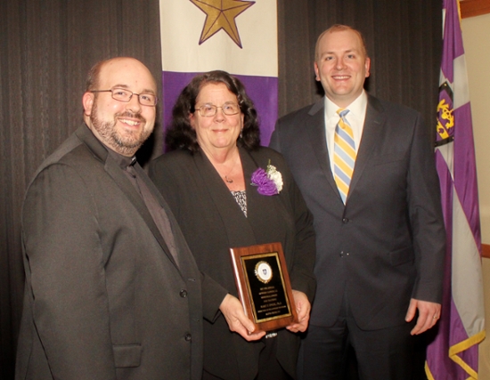 Mary F. Engel, Ph.D. (center), pictured with her sons Sam Sawyer, S.J. (left), and Michael Sawyer, J.D. ’04, was named The University of Scranton’s 2017 Alpha Sigma Nu Teacher of the Year at the honor society’s induction dinner on campus.   