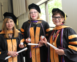 The University of Scranton introduced a new tradition at its graduate commencement ceremony on Saturday by presenting Coins of Excellence from its Alumni Society to all graduates. From left: Melissa L. Rickard of Honesdale, Marjorie Hottenstein of Blakeslee and Andrea Schall Mantione of Plains, Scranton’s first Doctor of Nursing Practice graduates, display the coins at the ceremony on campus.