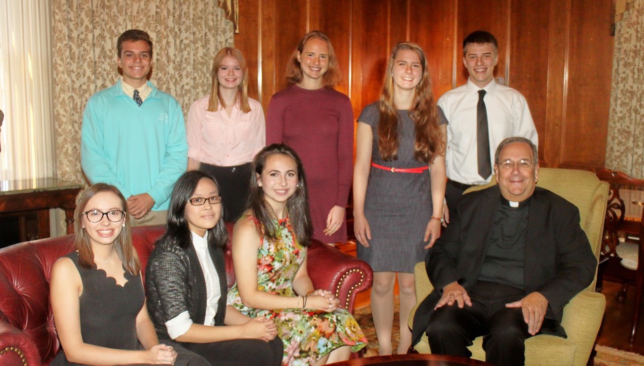 Nine members of The University of Scranton’s class of 2021 have been awarded four-year, full-tuition Presidential Scholarships. Pictured with Rev. Herbert B. Keller, S.J., interim president of the University (seated, far right), are, seated from left, Presidential Scholars Madison Heaton, Christine Jiang and Hannah Graff. Standing are Presidential Scholars Gabriel Ragusa, Megan Osborne, Amanda Tolvaisa, Molly Elkins and Jacob Myers. Absent from the group photo was Presidential Scholar Kate Wisner.