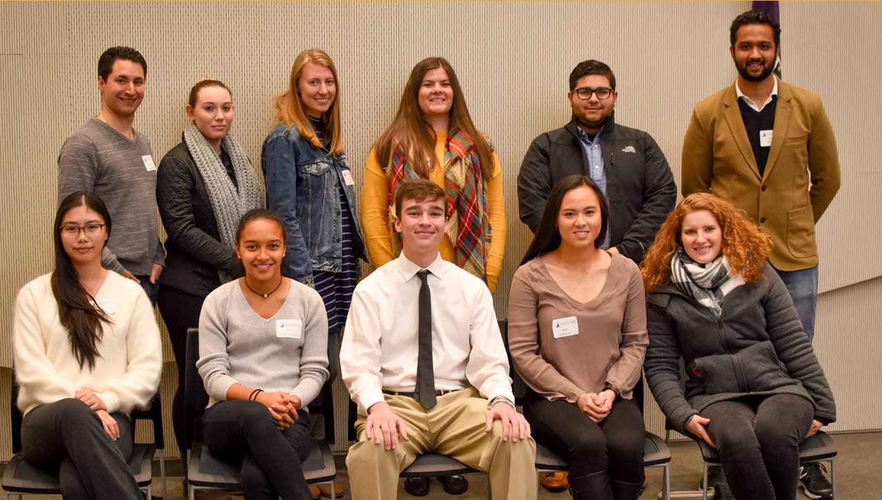 Joe Sorbera '08, back left, and Jessica Palmeri '11, G'13, front right, host nine students at a Beyond the Commons pre-dinner hot chocolate social in the Kane Forum.