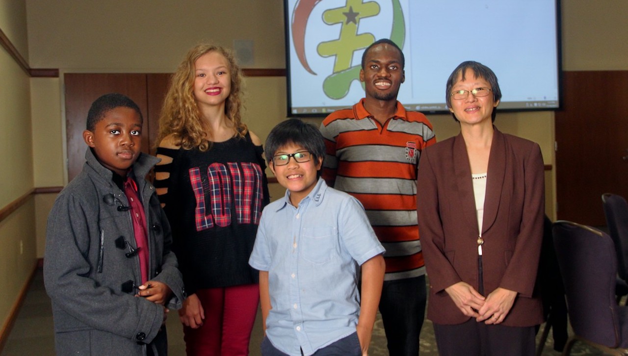 The University of Scranton hosted nearly 100 students from Prescott Elementary School, The Lutheran Academy and North Pocono Elementary and Middle School, who came to campus in November to hear Ekow Aikins, a MBA student at the University and a native of Ghana, talk about his country. The program was part of an International Education Week at the University. From left are: Nathan Graham, Scranton, a fourth-grade student at The Lutheran Academy; Aurora Lefever, Moscow, an eighth grade student at North Pocono Middle School; Treb Cacao, Scranton, a fifth-grade student at Prescott Elementary School; Aikins: and Huey Shi Chew, director of international students and scholar services at the University.