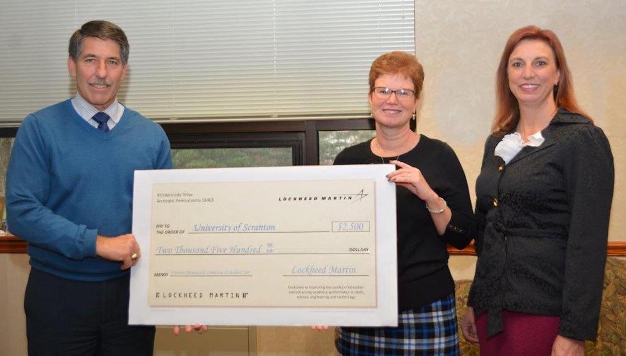 Lockheed Martin’s Archbald Operations presented a check to The University of Scranton in the amount of $2,500 to support their Veterans Advocacy Committee and veterans’ student club. From left: Peter Rosecrans, general manager of Lockheed Martin’s Archbald Operations (left) and Karen Buckley, Human Resources Manager of Lockheed Martin’s Archbald Operations (right) meet with Margaret Hambrose, director of corporate and foundation relations at The University of Scranton. 
