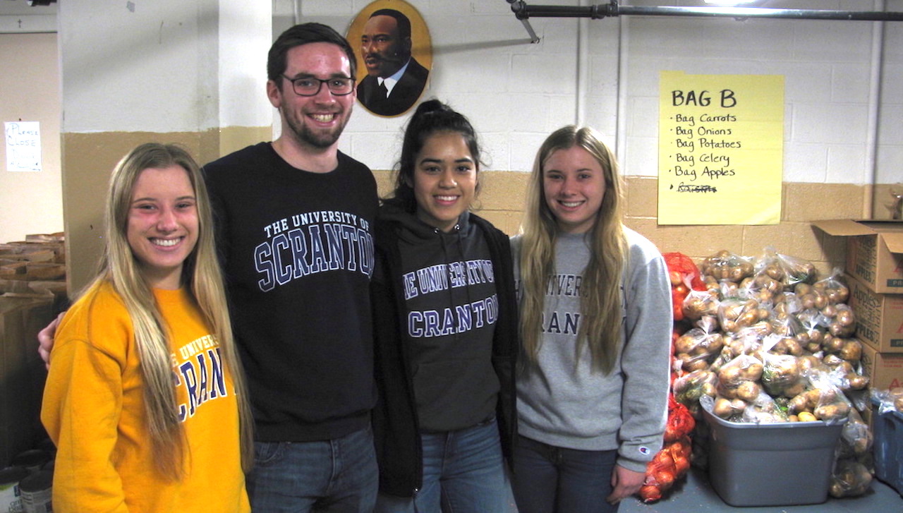 Among those preparing 225 Thanksgiving food baskets for area families in need are, from left: University students Makayla Wislotsky, a biology major from Ashland; Patrick Chapman, a psychology and counseling and human services double major from Yardley; Jessica Cabral, an accounting major from New Providence, New Jersey; and Alexis Wislotsky, a biology major from Ashland.