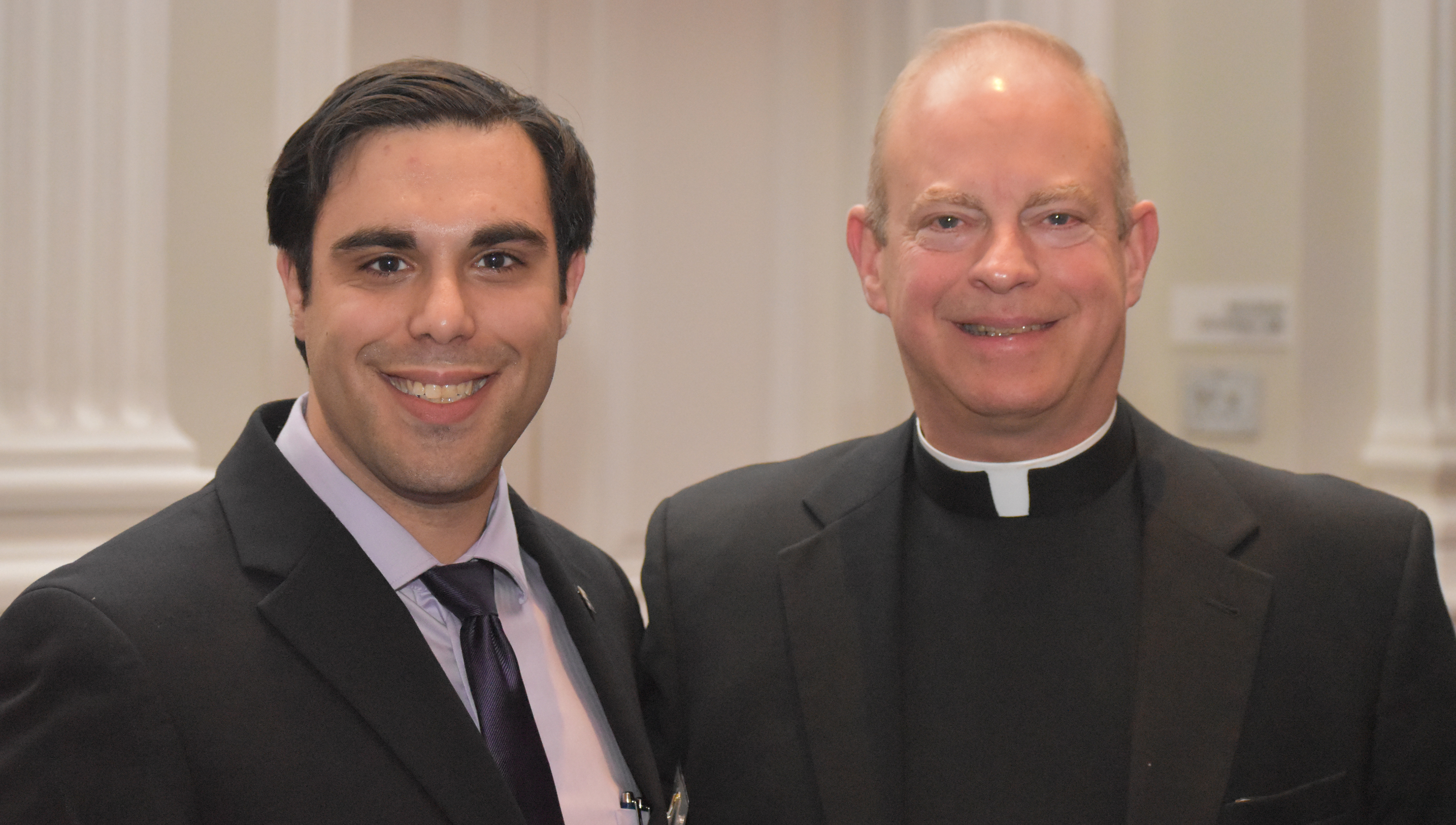 Danial Nadeem '14 celebrates the Christmas season with the Rev. Daniel Sweeney, S.J., Ph.D., assistant professor of Political Science at the University. 