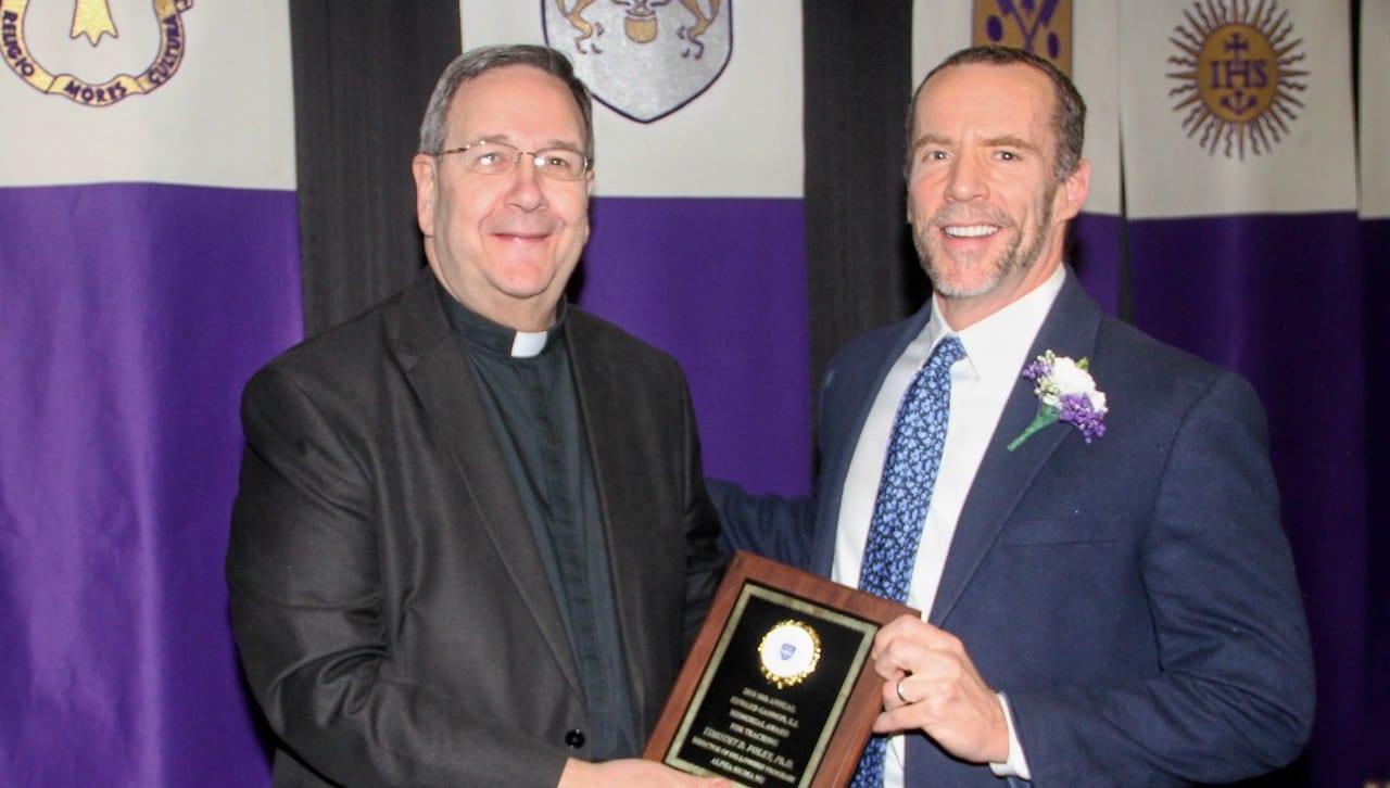 From left: University of Scranton Interim President Rev. Herbert B. Keller, S.J., presents Timothy Foley, Ph.D., professor of chemistry, the University’s 2018 Alpha Sigma Nu Teacher of the Year at the honor society’s induction dinner on campus.