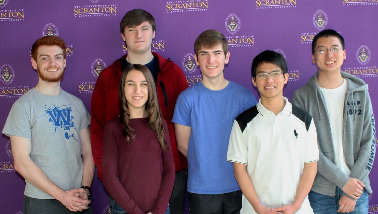 Teams from Scranton Preparatory School came in first place and third place at The University of Scranton’s annual Computer Programming Contest. From left: Sean McTiernan, Scranton, a sophomore at The University of Scranton majoring in computer science; and members of the Scranton Preparatory student team 1 that won the competition Kailey Bridgeman (front), Colin Pierce and Charles Kulick; and Scranton Preparatory students in team 2 that placed third in the competition Cuong Nguyen and Ryan Chan. Patrick Clemens, director of technology at Scranton Preparatory School and the coach of both teams, was absent from the photo.