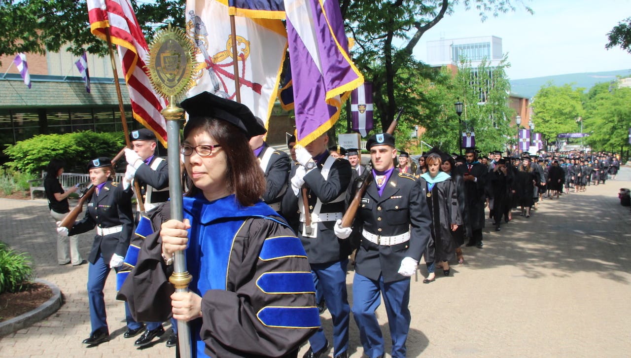 Grand Marshal and Mace Bearer Ann Pang-White, Ph.D., professor of philosophy and director of Asian studies at The University of Scranton, leads the academic procession on the University’s Commons. The University conferred nearly 600 master’s and doctoral degrees at its graduate commencement ceremony on May 26 in the Byron Recreation Complex.