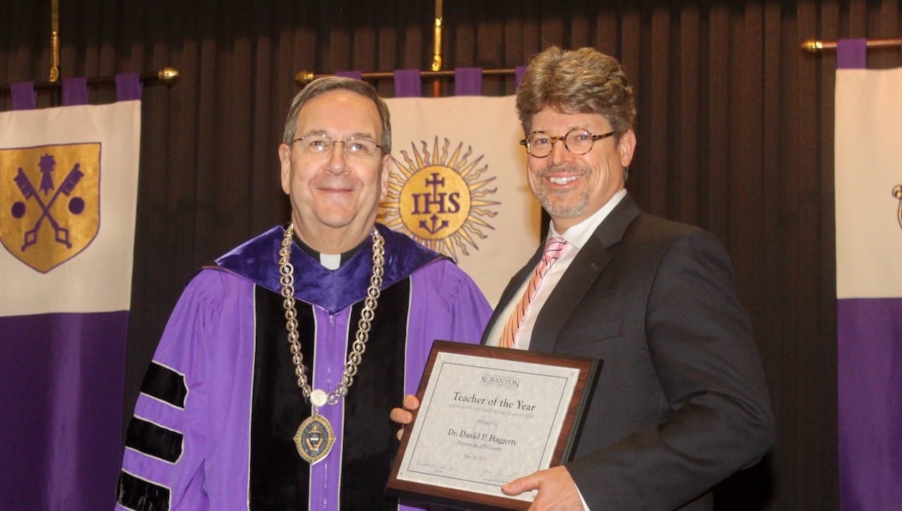 From left: Rev. Herbert B. Keller, S.J., interim president of The University of Scranton presents the University’s class of 2018 Teacher of the Year award to Daniel Haggerty, Ph.D., professor of philosophy and director of the Special Jesuit Liberal Arts Honors Program.