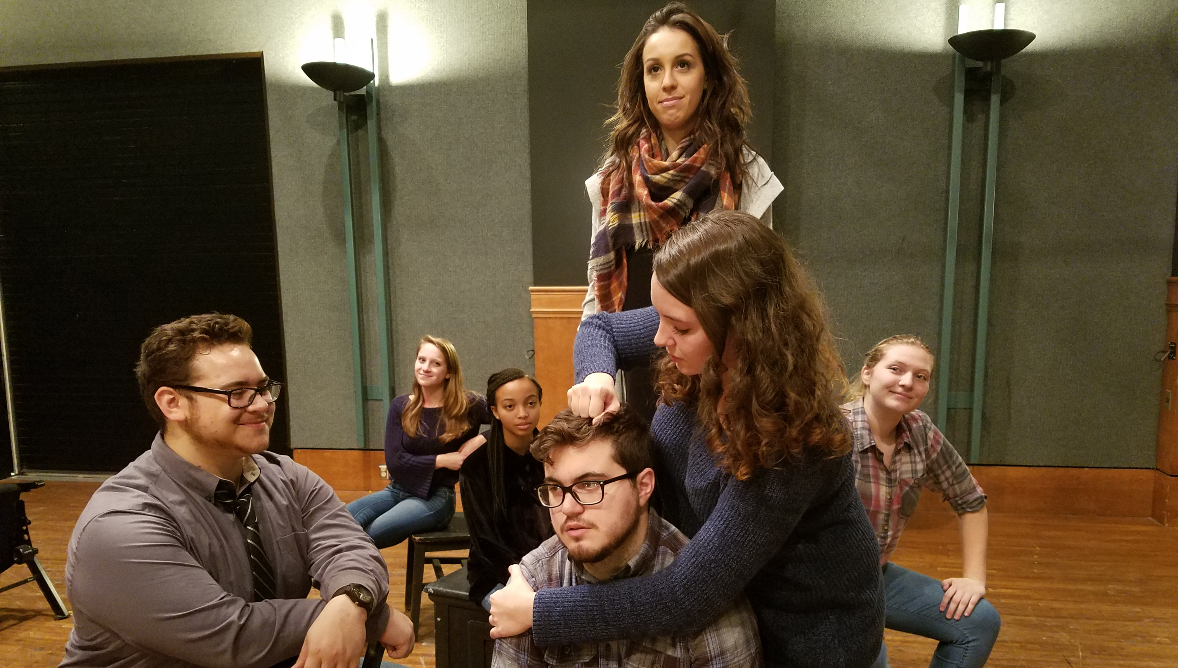 Zachary Pavlocak (dress shirt & tie), Ali Basalyga (back left), Nia Moore (black shirt), Nicolas Gangone (front, glasses), Julia Consiglio (standing, scarf), Victoria Pennington (blue sweater), and Ellie Rosentel (far right, plaid shirt)