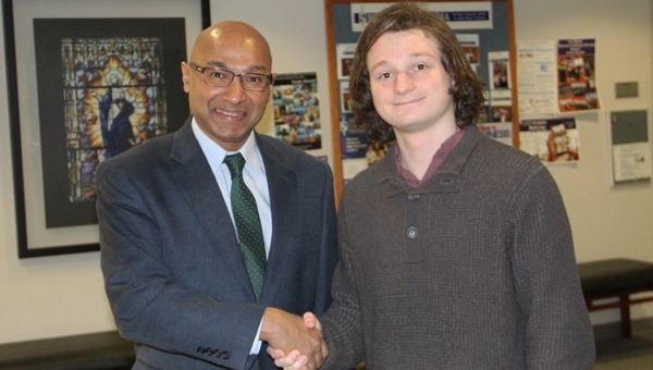 University of Scranton senior Michael Spadavecchia, Moonachie, New Jersey, received one of only four scholarships awarded in 2018 by Sigma Nu Tau, the national honor society for entrepreneurship. From left, Murli Rajan, Ph.D., interim dean of the Kania School of Management, congratulates Spadavecchia, an entrepreneurship major, president of the University’s entrepreneurship club and member of Sigma Nu Tau.