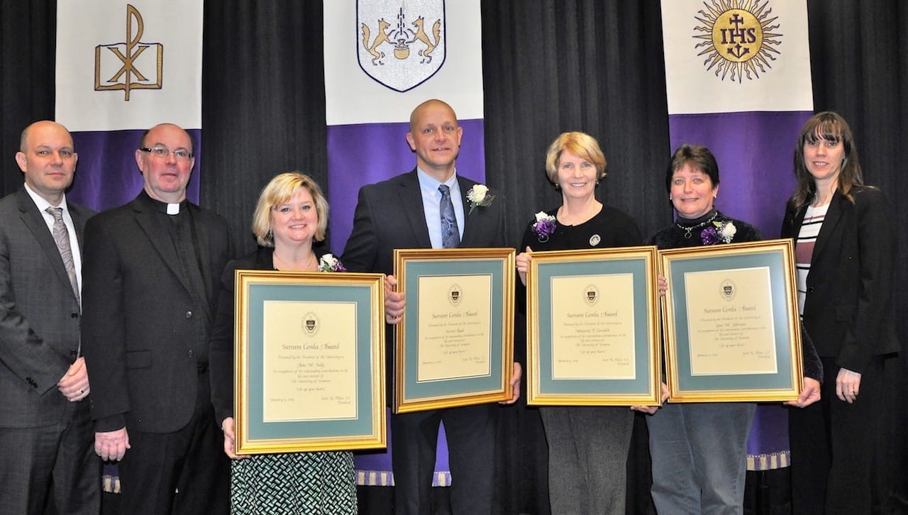 The University of Scranton presented Sursum Corda (Lift Up Your Hearts) Awards to four staff members at a convocation held on campus this month. The award recognizes members of the University’s professional/paraprofessional staff, clerical/technical staff and maintenance/public safety staff who have made outstanding contributions to the life and mission of the University. Pictured, from left, are: Jeffrey Gingerich, Ph.D., senior provost and vice president of academic affairs; Rev. Scott R. Pilarz, S.J., president; Sursum Corda Award recipients Tara Seely, Kevin Rude, Maureen Castaldi and Jane Johnson; and Patricia Tetreault, vice president for human resources.
