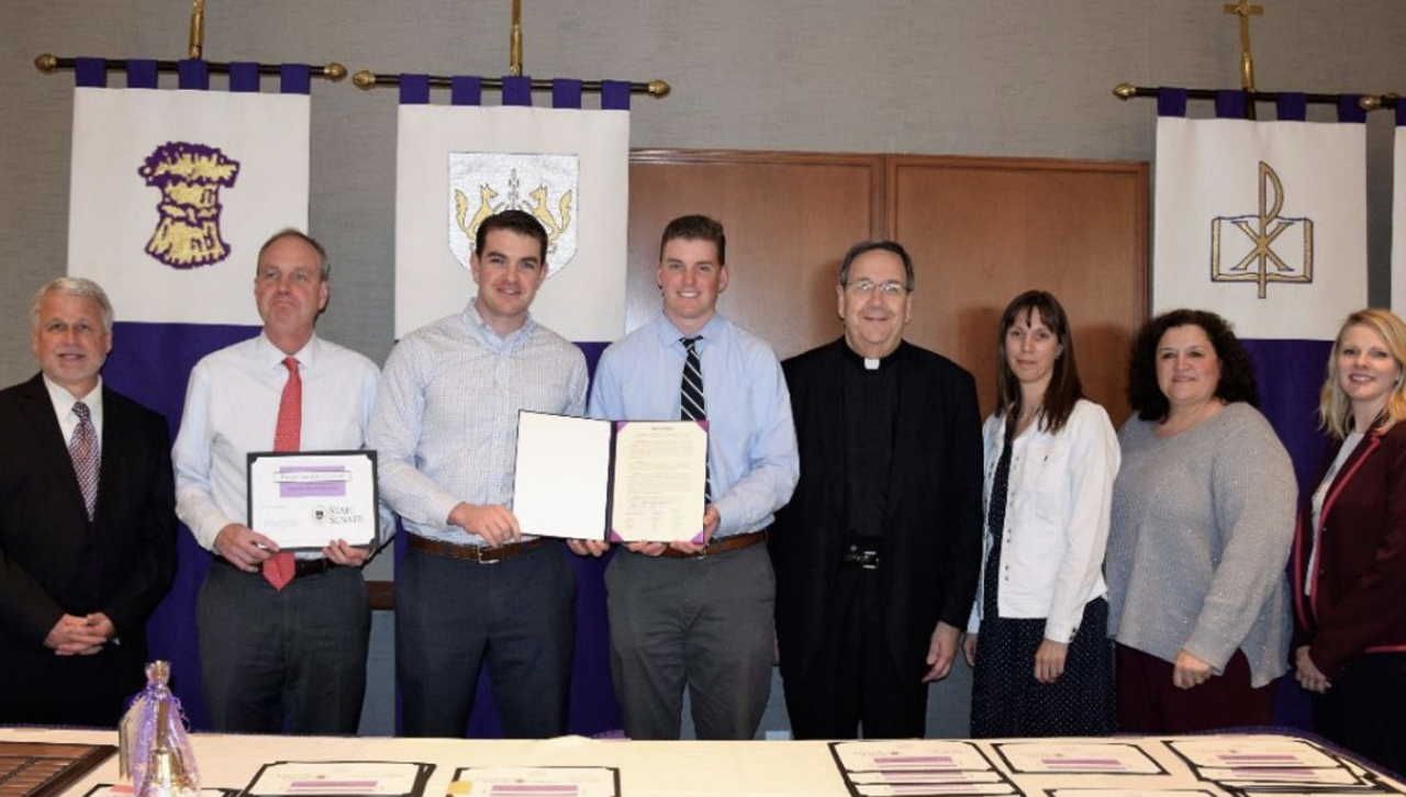 Meg Cullen-Brown's family receiving the proclamation regarding the renaming of the Spirit Award to the Meg-Cullen Brown Magis Award.