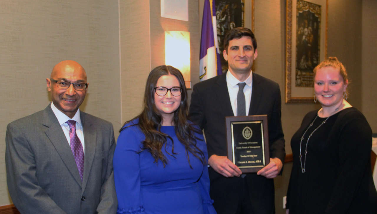 From left: Murli Rajan, Ph.D., interim dean of KSOM, Katie Conrad, member of the University's Business Club, Vincent Rocco, recipient of the KSOM "Professor of the Year" award, and Alexandra Turner, member of the University's Business Club.