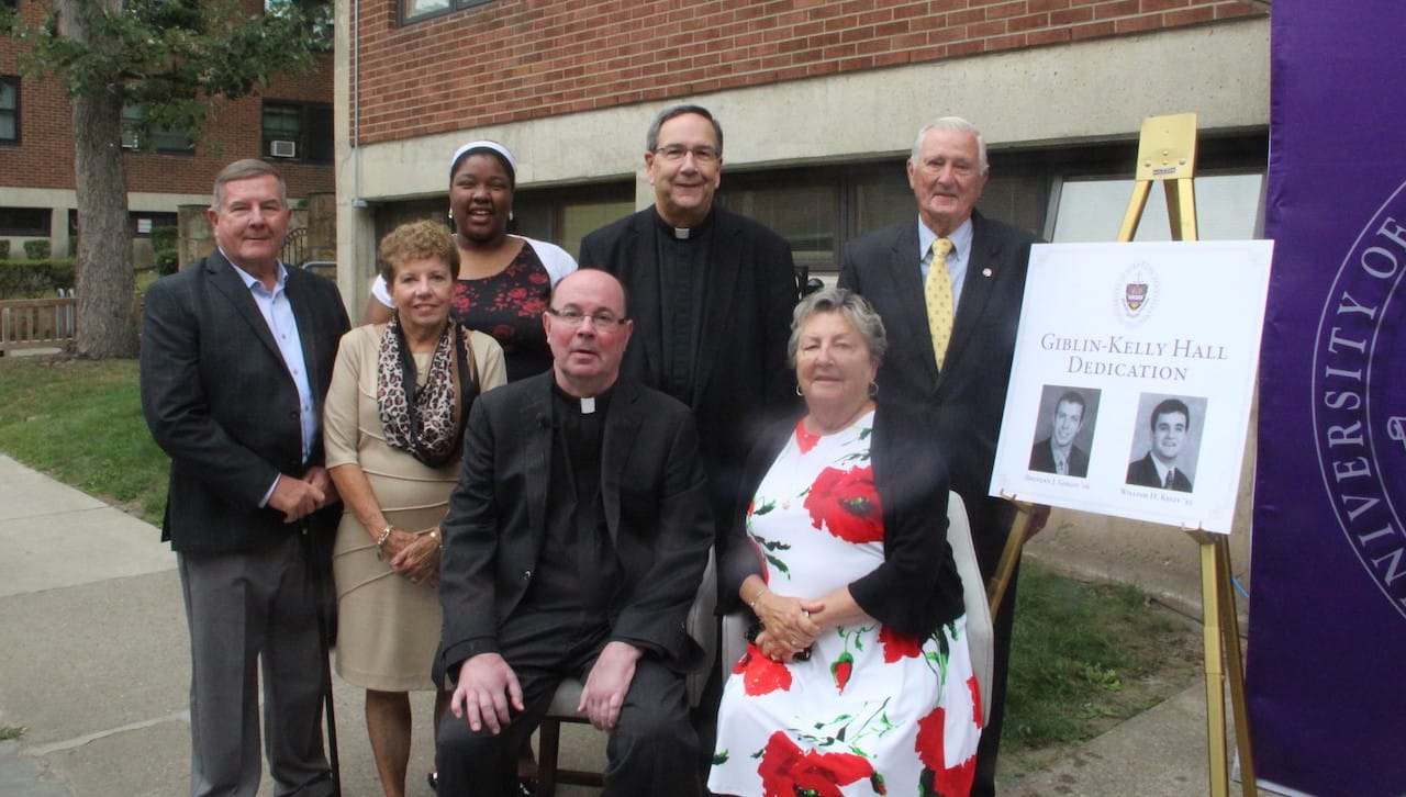 The University of Scranton dedicated a residence hall in honor of the late Brendan J. Giblin of the class of 2006, and the late William H. Kelly Jr. of the class of 1993. From left are: Joe and Mary Giblin, parents of the late Brendan Giblin; University student Kim Baxter, recipient of the Giblin Scholarship who spoke at the ceremony; Rev. Scott R. Pilarz, S.J., president; Rev. Herbert B. Keller, S.J., vice president for mission and ministry; and Joanne and Bill Kelly, parents of the late William Kelly. 