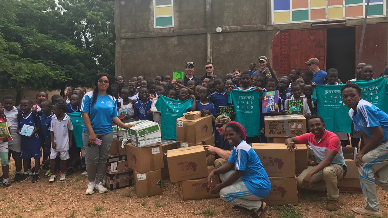 Children from the village of Garoua, standing in front of their school with University of Scranton donations. Their beautiful smiles express our thanks better than these words ever could.  