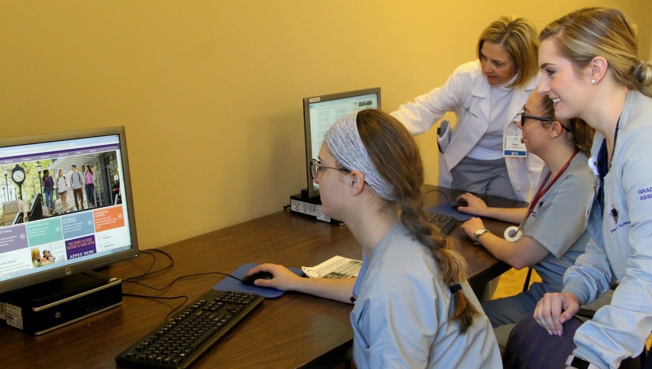 This 2019 photo shows students and faculty with computers donated by Regional Hospital of Scranton to support student nurses participating in The University of Scranton Clinical Liaison Nurse Model Academic Practice Partnership at the hospital. From left: student nurse Madison Negast, Branchburg, New Jersey (seated); Sharon Hudacek, Ed.D., professor of nursing at the University; student nurse Jacklyn McGovern, Bellmore, New York (seated); and graduate assistant Lauren Jurbala, Avoca, a graduate student in the University’s Family Nurse Practitioner Program.