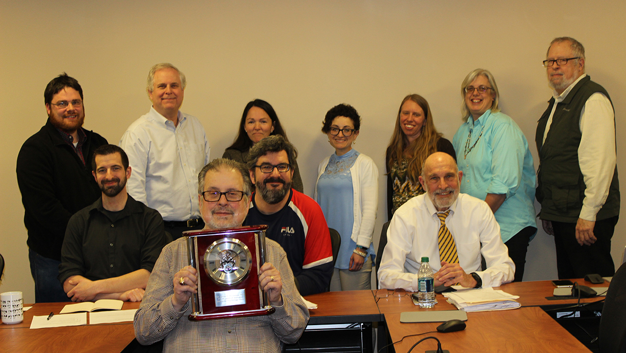 The late James P. Buchanan, Ph.D. (center with clock) with members of the University's Psychology Department