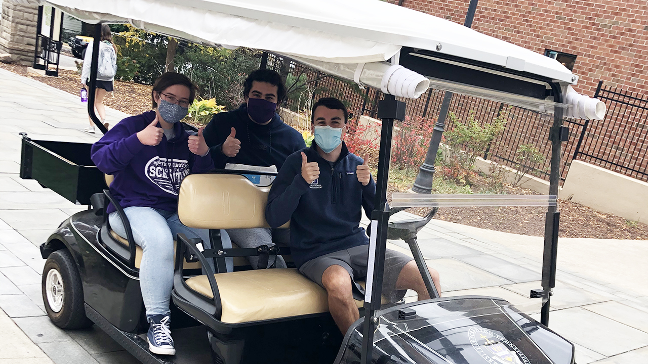 Student volunteers deliver meals on campus.