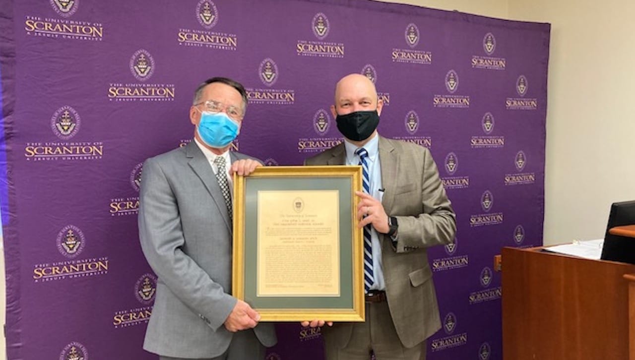 Leonard G. Gougeon, Ph.D., Distinguished Professor of English and Theatre at The University of Scranton, received the John L. Earl III Award for 2020. The award was presented as part of a virtual faculty award ceremony held in April. From left are Dr. Gougeon and Jeff Gingerich, Ph.D., acting president, provost and senior vice president for academic affairs at The University of Scranton.