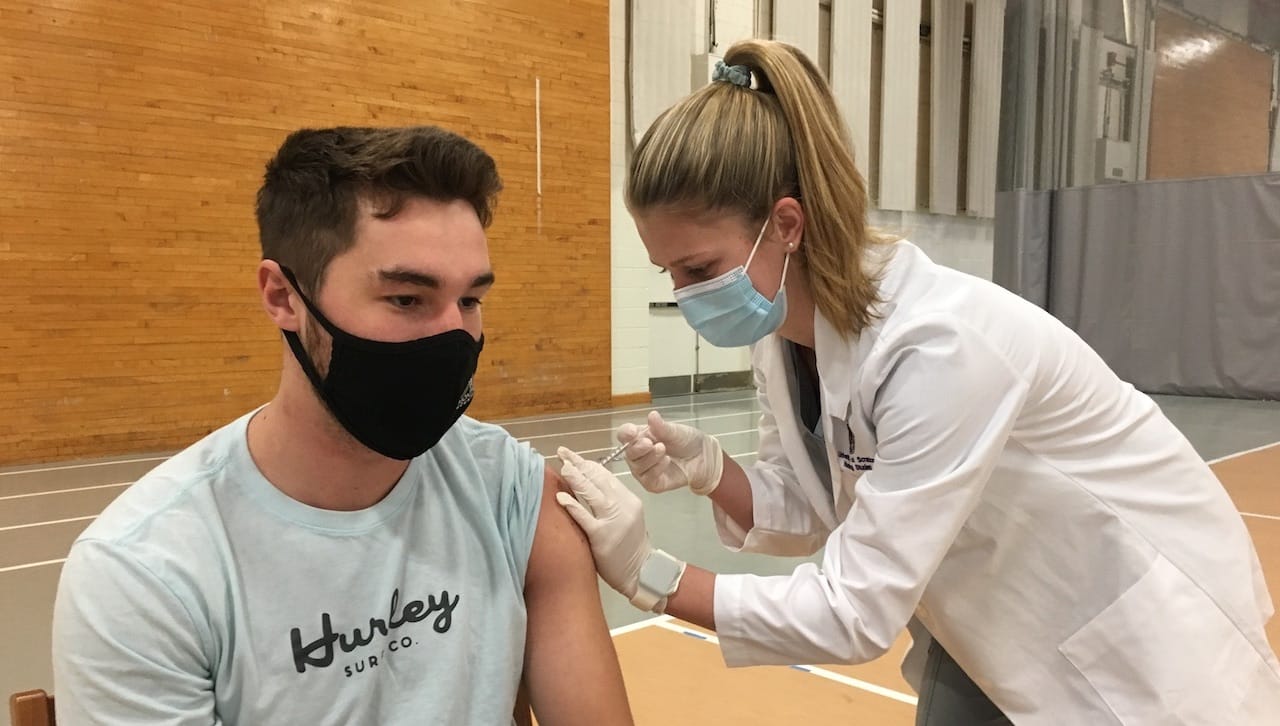University of Scranton student nurse Amanda Ring of Bridgewater, New Jersey, administers a Pfizer vaccine to Ian Smith, a marketing major from North Wales, at a COVID-19 vaccination clinic held on campus.