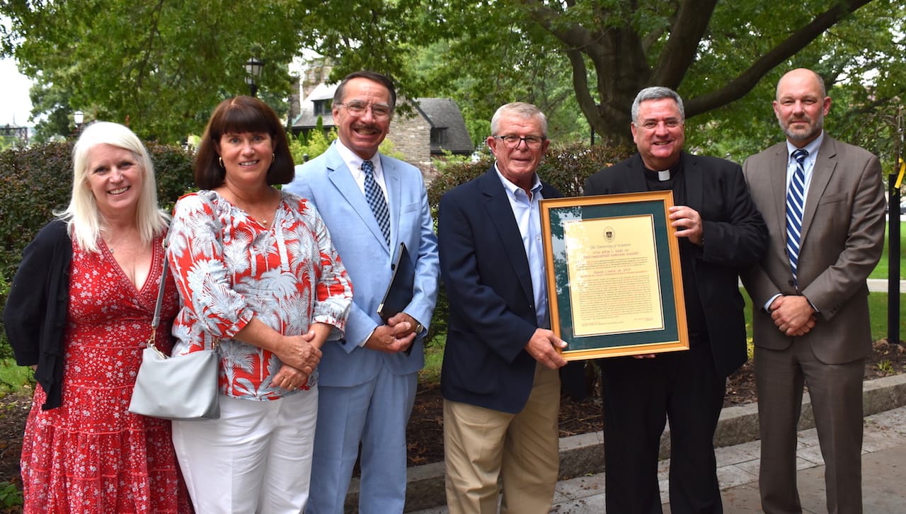 Daniel J. West Jr., Ph.D., professor and chair the Health Administration and Human Resources Department at The University of Scranton, received the John L. Earl III Award for 2021. From left are: Jacqueline Earl Hurst and Karen Earl Kolon, M.D. ’85, daughters of the late John Earl; Leonard G. Gougeon, Ph.D., Distinguished Professor of English and Theatre and the 2020 John L. Earl III Award recipient; Dr. West; Rev. Joseph Marina, S.J., president; and Jeff Gingerich, Ph.D., provost and senior vice president for academic affairs.