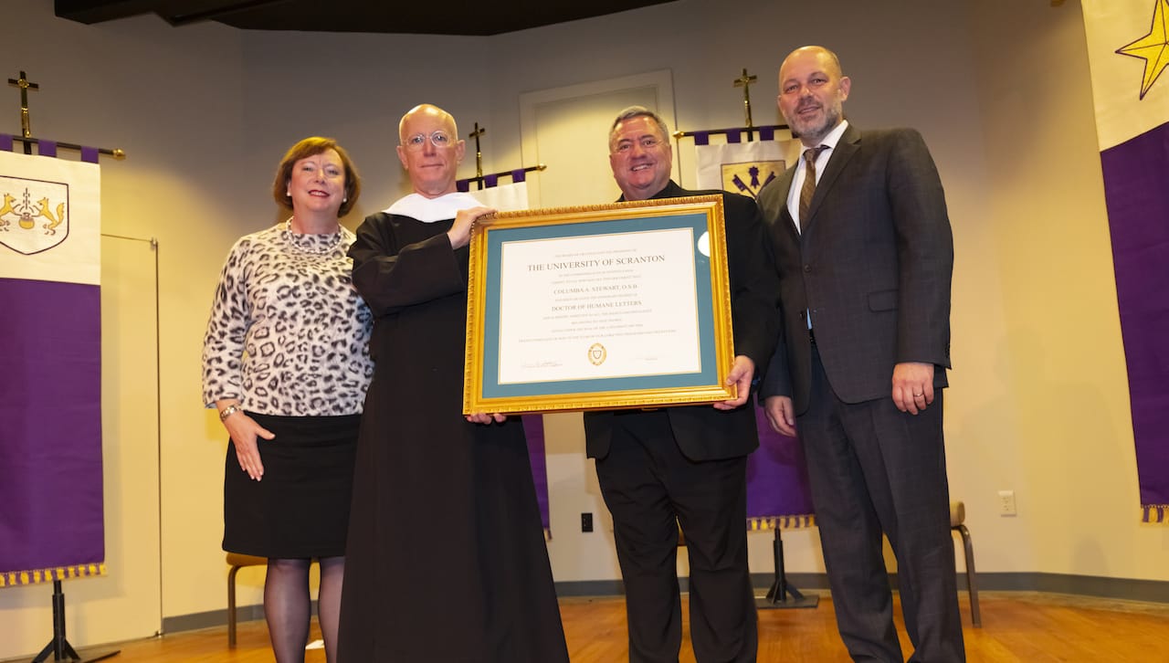 Father Columba Stewart, O.S.B., executive director of the Hill Museum and Manuscript Library at St. John’s University, received an honorary degree from The University of Scranton at its Fall Lecture in the Humanities, which was held on campus Oct. 21. From left: Gretchen J. Van Dyke, Ph.D., associate professor of political science; Father Stewart; Rev. Joseph Marina, S.J., president; and Jeff Gingerich, Ph.D., provost and senior vice president for academic affairs.