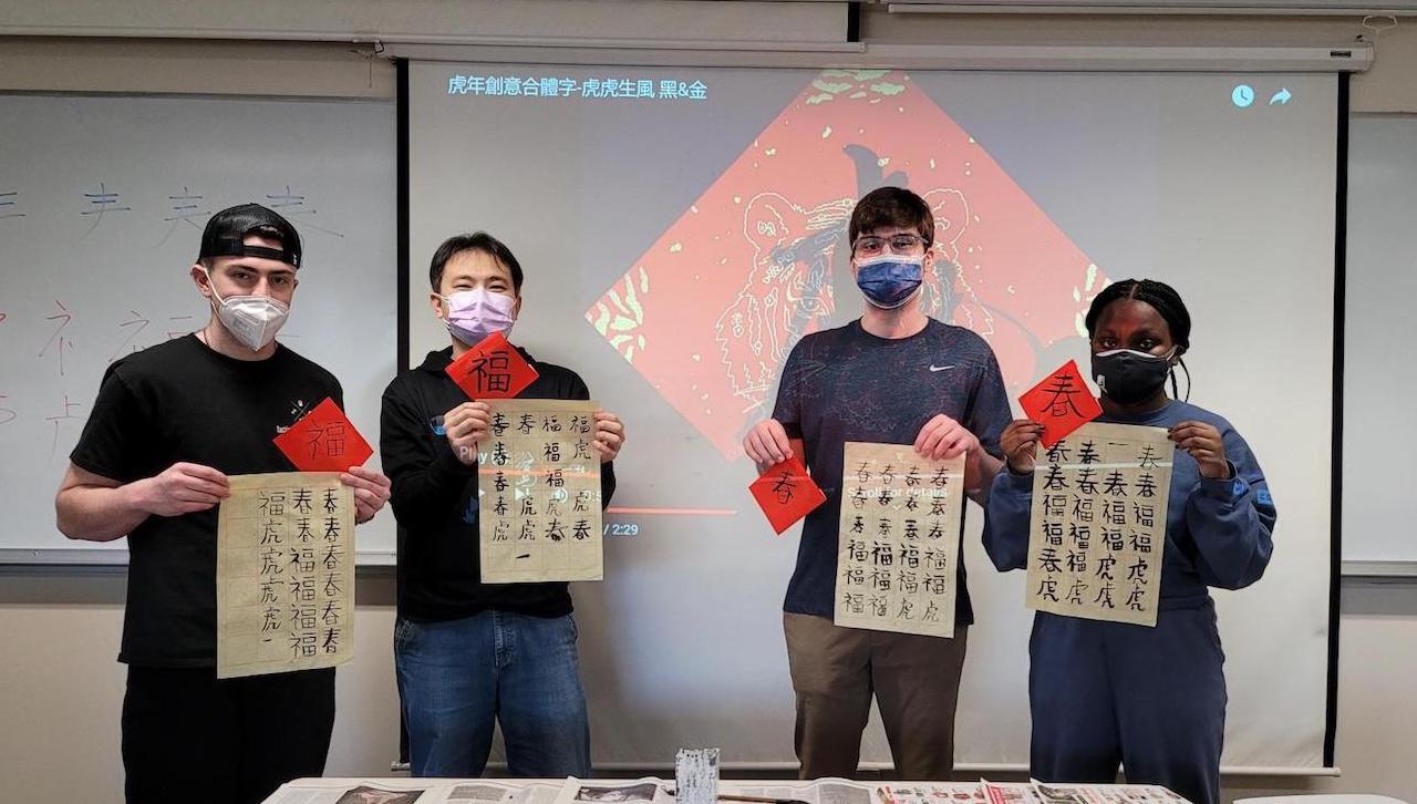 The Asian Studies Program/concentration at The University of Scranton will host Asian New Year Festival and Workshop on Feb. 24 that includes hands-on lessons on Chinese calligraphy and Japanese origami. Registration is required to attend the program which begins at 6 p.m. in the Rose Room of Brennan Hall. From left: Declan Maurer, White House Station, an accounting major and a student in an advanced Chinese class; Prof. Peter (Chun Sheng) Su, instructor of Chinese classes who is from Taiwan; Devin Perry, Sterling, Massachusetts, a communication major and student in an intermediate Chinese class; and Jenyah Cunningham, Brooklyn, New York, a secondary education – English major and a student in an intermediate Chinese class. 