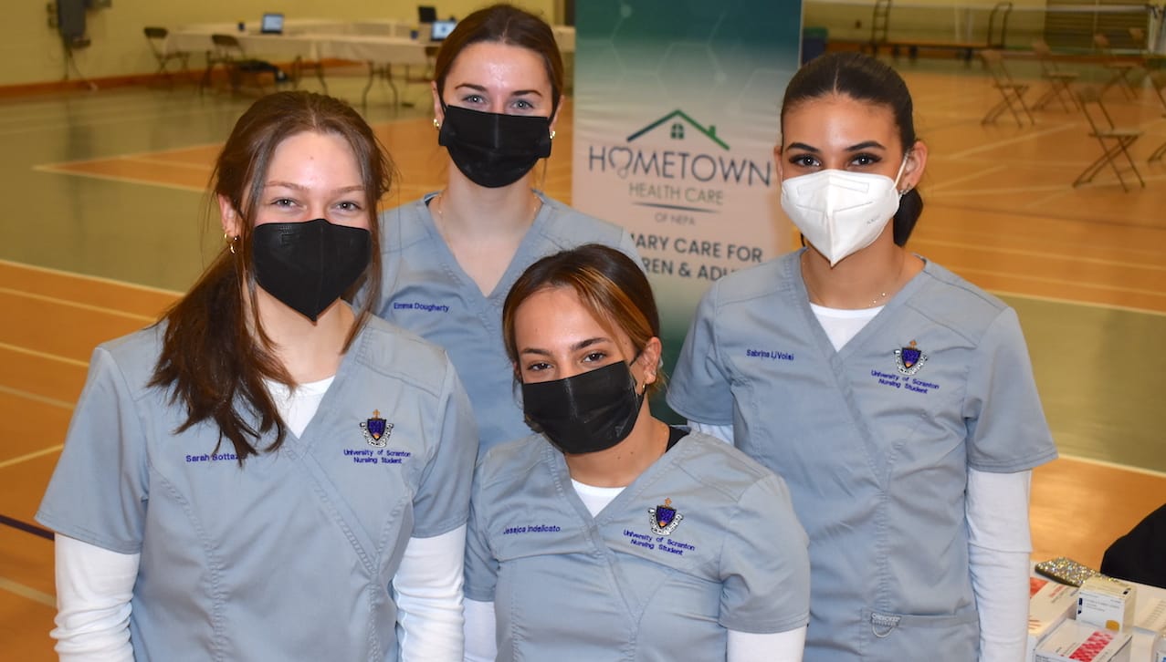 Students enrolled in The University of Scranton’s nursing program helped to administer COVID-19 vaccination boosters at a clinic on campus on Feb. 17. Front row, from left: Sarah Bottazzi, New Providence, New Jersey; and Jessica Indelicato, Bethlehem. Back row: Emma Dougherty, Huntington, New York; and Sabrina LiVolsi, Washingtonville, New York.