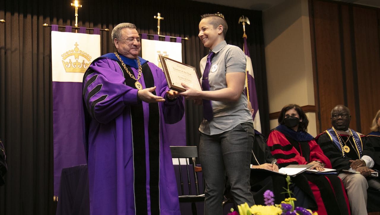 The University of Scranton’s graduating class of 2022 named Billie R. Tadros, Ph.D., assistant professor in the English and theatre, as Teacher of the Year. From left, University of Scranton President Rev. Joseph Marina, S.J., presents the Teacher of the Year award to Dr. Tadros at Class Night.