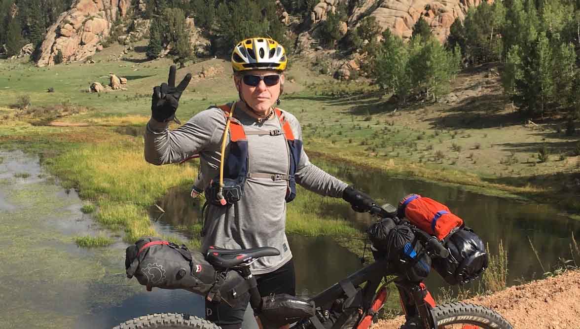 John O’Malley ’87, Lieutenant Colonel, US Army Retired, pauses for a moment while riding in the wilderness.