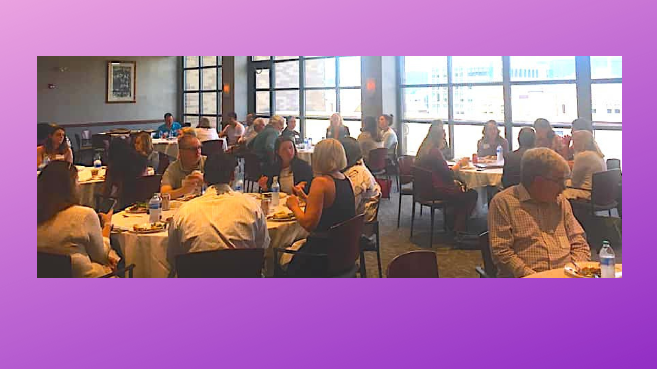 Image of people seated at dining tables conversing