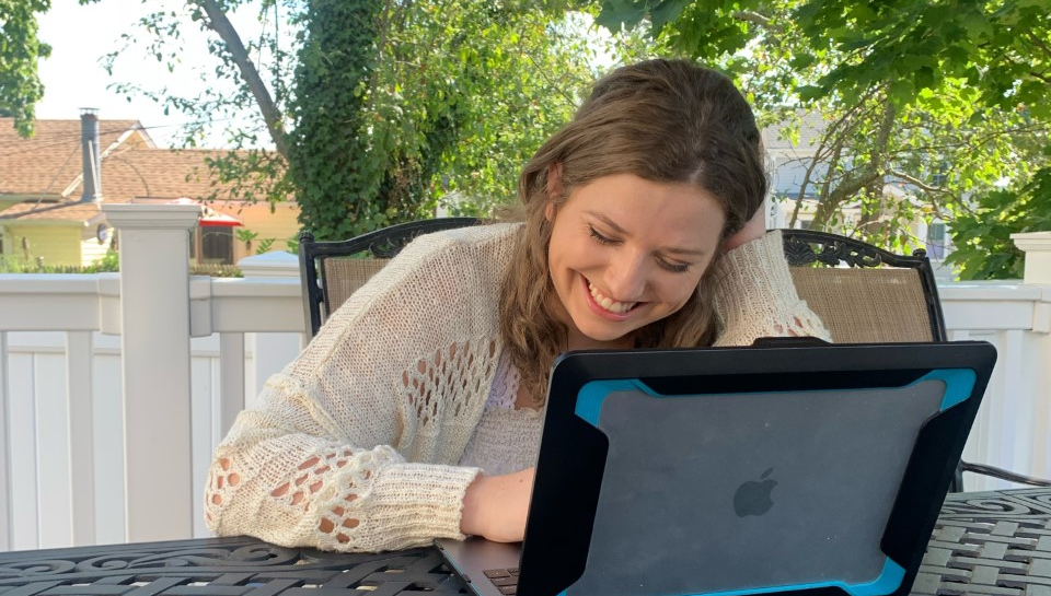 Katherine Posillico '23, shown with her laptop, talks about her experience as an OT Intern at a hospital.